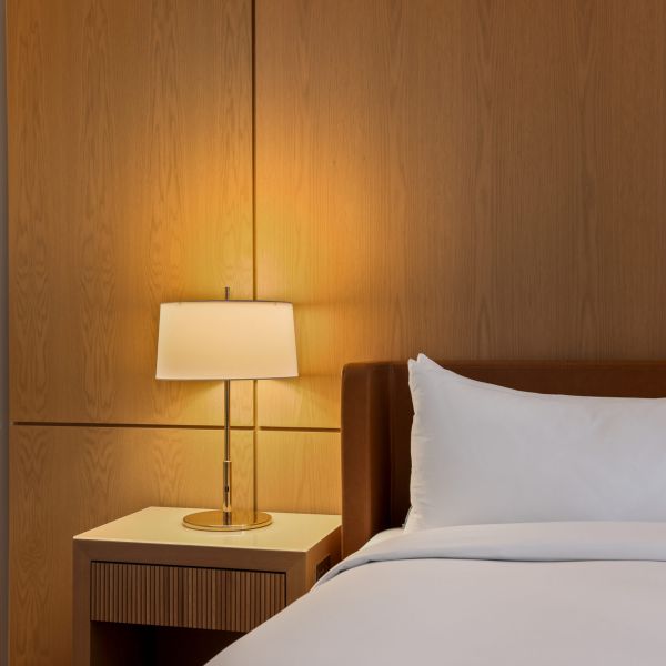commercial boutique hotel room bed with side table