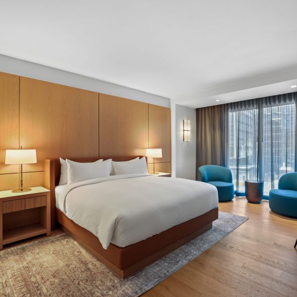 commercial boutique hotel guest room bed and wall